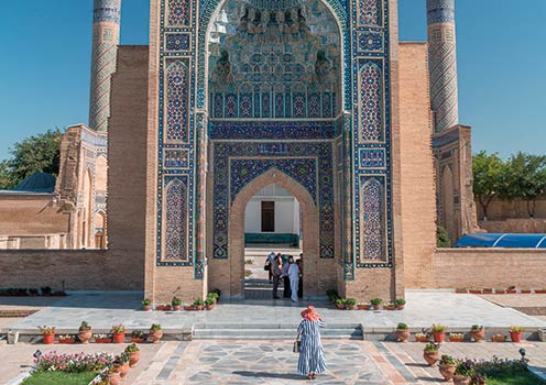 A woman walking towards Gur Emir Mausoleum in Samarkand, Uzbekistan